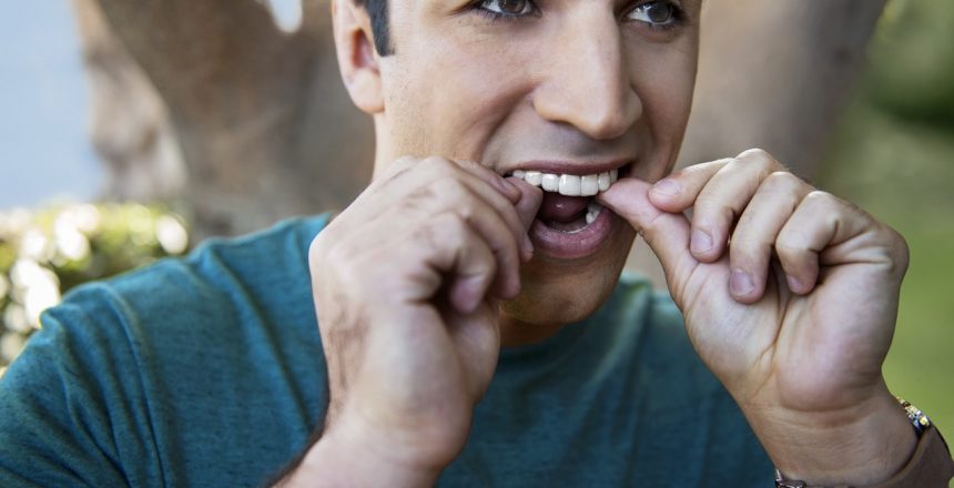 man adjusting his aligners