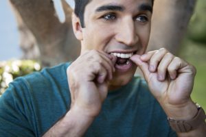 man adjusting his aligners